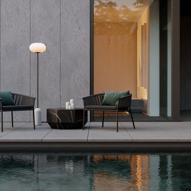 Two Afton Outdoor Lounge Chairs With Arcadia Cushions, Blackt Cord, And Black Frame On a Patio Adjacent To Pool