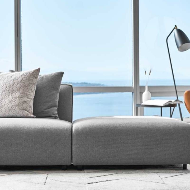 Close Up The Arya Modular Sectional in Porpoise Fabric and Color in a Living Room Next to Window Overlooking Ocean