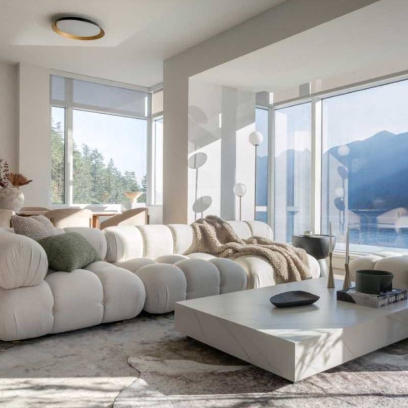 Angled View of The Belia Modular Sectional With Alesund Fabric in a Living Room Next to Window Overlooking Bay