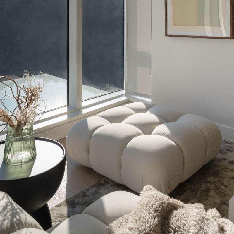 The Belia Modular Sectional Ottoman in Alesund Fabric and Color in a Living Room Next to Window