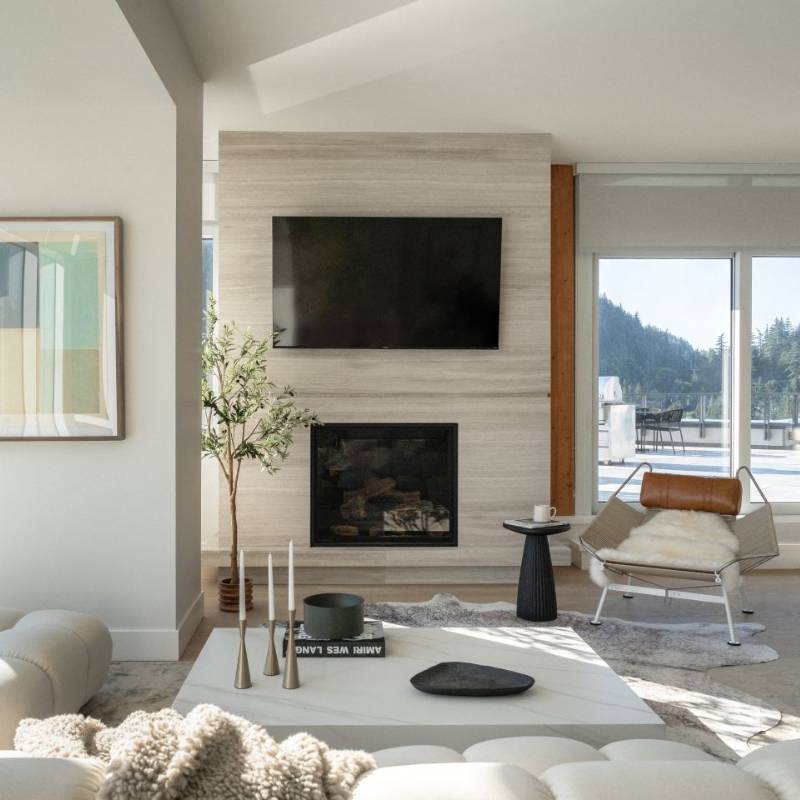 A Flag Halyard Chair With Trento Morocco Headrest and Sheepskin throw In a Living Room Overlooking a Sliding Glass Door Leading To a Patio