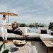 Couple Enjoying Wine With Pool In The Background While Sitting On The Francis Outdoor Modular Sectional Sofa In Palisades Color With Black Base