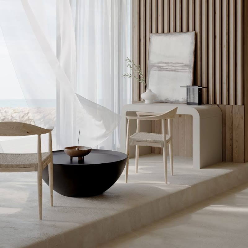 View Of a Galen Coffee Table In Black Concrete In Between Two Chairs Next To a Window