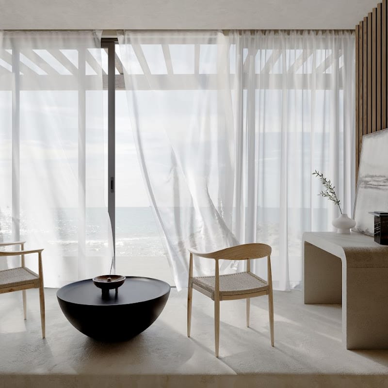 View Of a Galen Coffee Table In Black Concrete In a Living Room Between Two Chairs