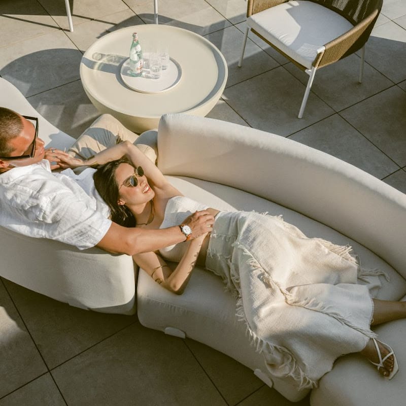 Overhead View Of a Galen Coffee Table In Alabaster Concrete Next To a Couple On a Couch