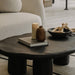 The Kara Coffee Table With Black Concrete Surface in Living Room Next to Couch