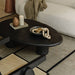 Close up View of The Kara Coffee Table With Black Concrete Surface With Candle and Other Decorations