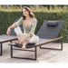 Woman Sitting On The Edge Of a Linnea Outdoor Lounger in White