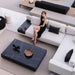 Overhead View Of Woman Sitting On A Couch In Front Of a Liza Coffee Table With Black Pietra Ceramic Surface