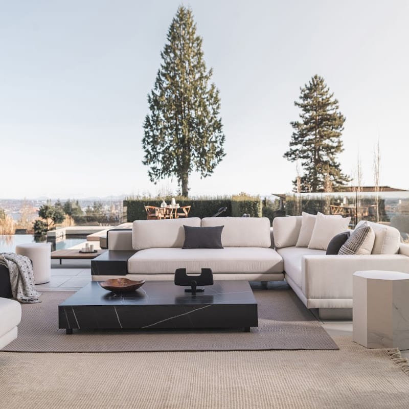 Liza Coffee Table With Black Pietra Surface in a Lounging Area On a Patio