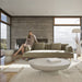 Wide Angle Front Facing View of the Maria Coffee Table in Alabaster Concrete in a Living Room 