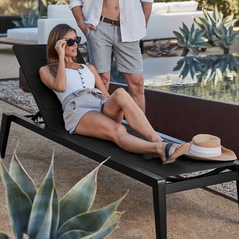 Woman Laying On The Preston Outdoor Lounger In Black