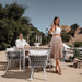 Couple Posing With a White Spencer Outdoor Dining Table With Pierre Outdoor Chairs