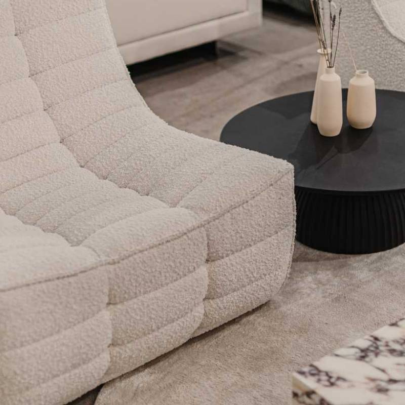 Close Up of The Tanner Sectional Sofa in Pearl Color and Fabric Next to a Side Table