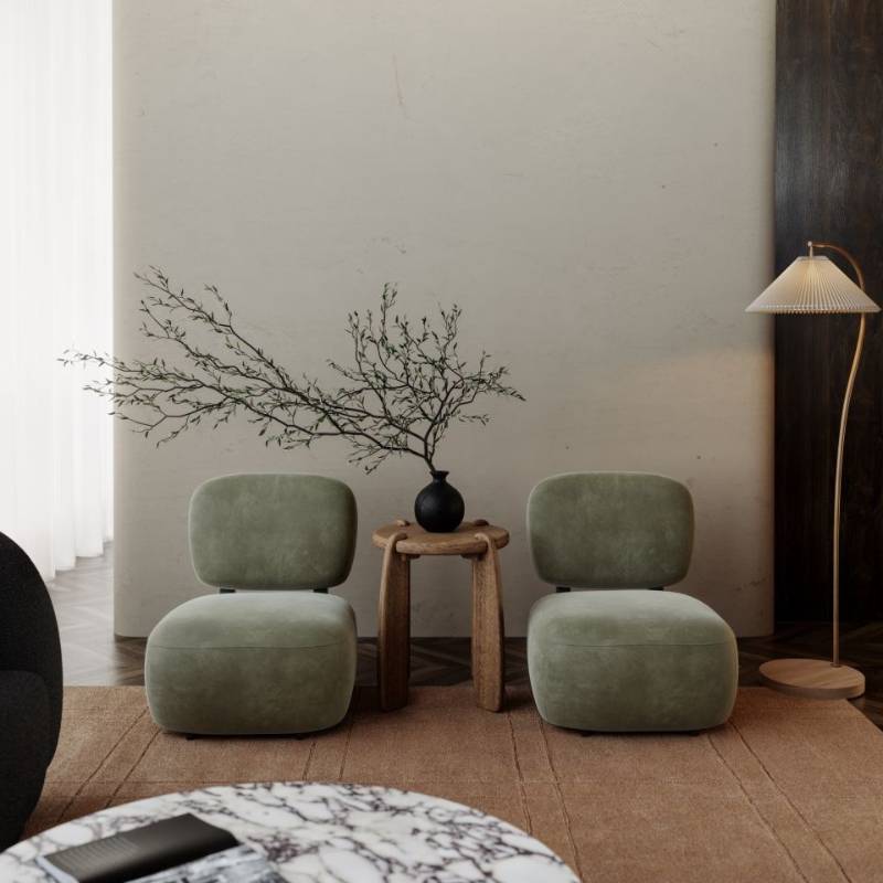 Front Facing View of Two Toro Lounge Chairs in Sage Vegan Suede Fabric Against a Living Room Wall