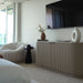 A Vonn Lounge Chair in Pearl Fabric in the Corner of a Living Room Nest to Sliding Glass Door