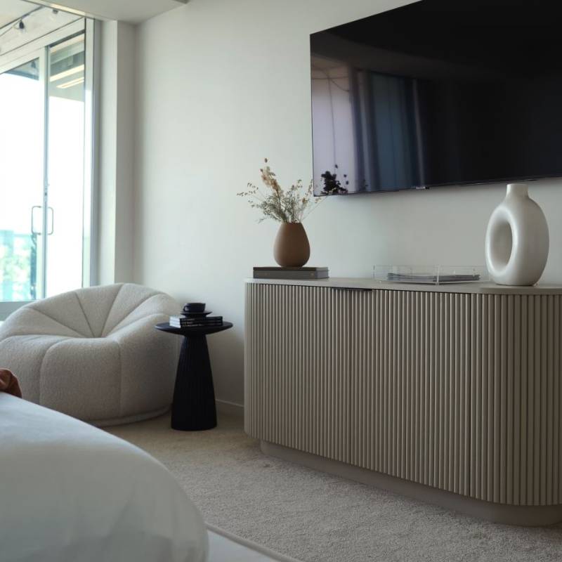 A Vonn Lounge Chair in Pearl Fabric in the Corner of a Living Room Nest to Sliding Glass Door