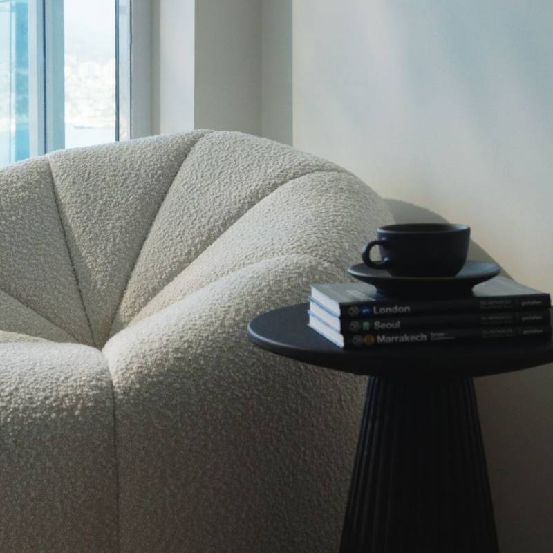 Close Up View of The Vonn Lounge Chair in Pearl Fabric in The Corner of a Living Room Next to a Coffee Table