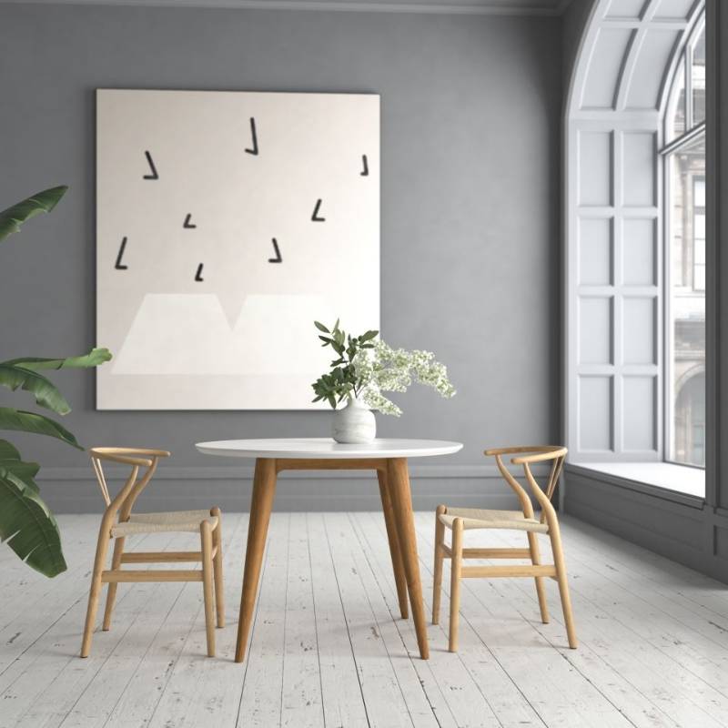 Two Wishbone Chairs in Natural Seat Cord and Natural Wood Finish at a Dining Table