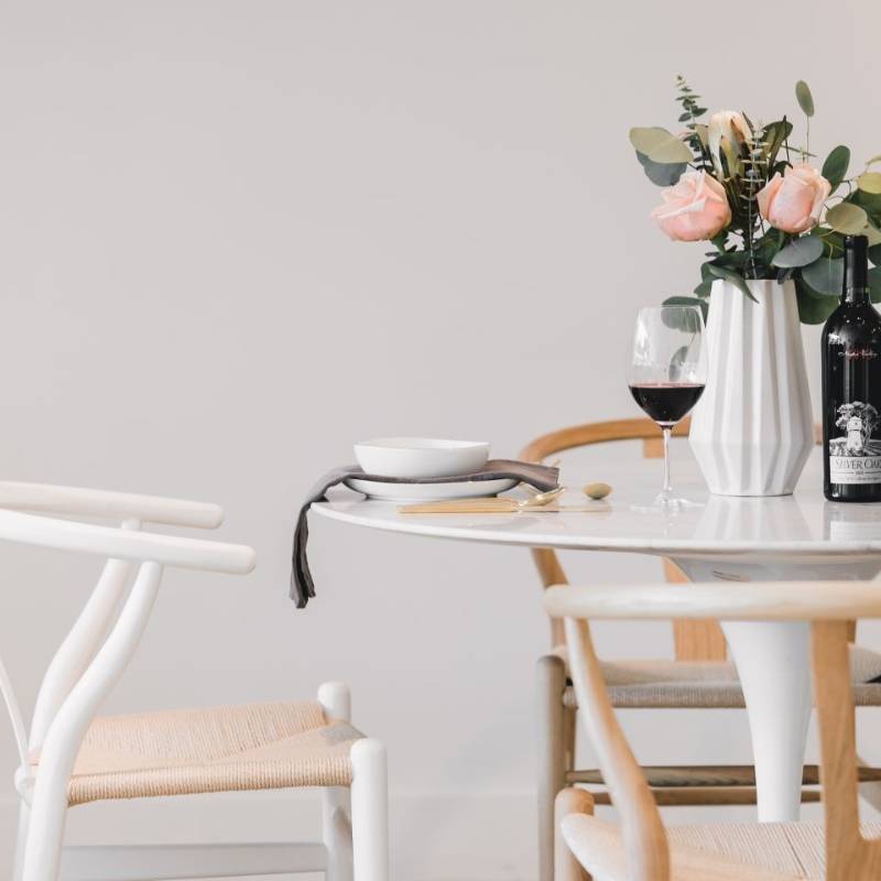 Close Up View of a Wishbone Chair in Natural Seat Cord at a Dining Table