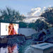 Yolo Outdoor Wall Mounted TV In Backyard Overlooking a Shark Water Slide