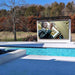 YOLO Outdoor Wall Mounted TV Next to Pool and Small Bridge