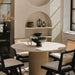 Close Up of The Athena Dining Round Table In White Travertine and Alabaster Matte Lacquer Wood Finish in a Dining Room