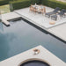 Elaine Dining Table With Black Pietra Ceramic Surface and Black Base on a Deck Next to a Pool