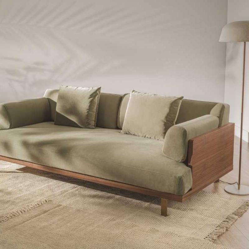 The Maria Sofa in Olive Green Fabric and Color Against a Wall in a Living Room