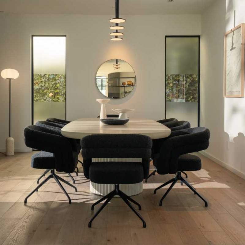 Side  Facing View of The Osten Table in Alabaster Matte Lacquer Finish and Alabaster Concrete Base in a Dining Room With Windows