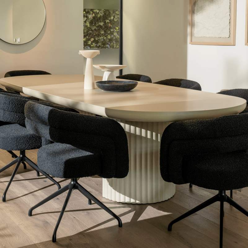 Angled View of The Osten Table in Alabaster Matte Lacquer Finish and Alabaster Concrete Base in a Dining Room With Wood Floors