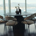 Several Uma Dining Chairs in Latte Fabric and Color at a Dining Table Next to Window Overlooking The Bay