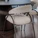 Rear Close Up View of The Uma Dining Chair in Latte Fabric and Color at a Dining Table