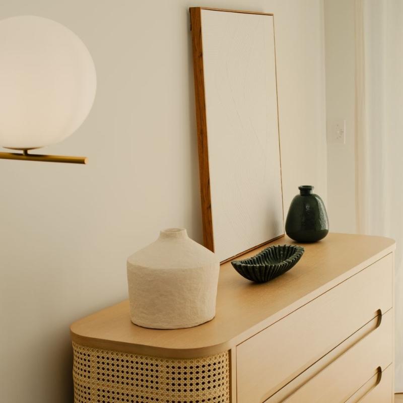 Angled Side View of The Wishbone Dresser in a Bedroom